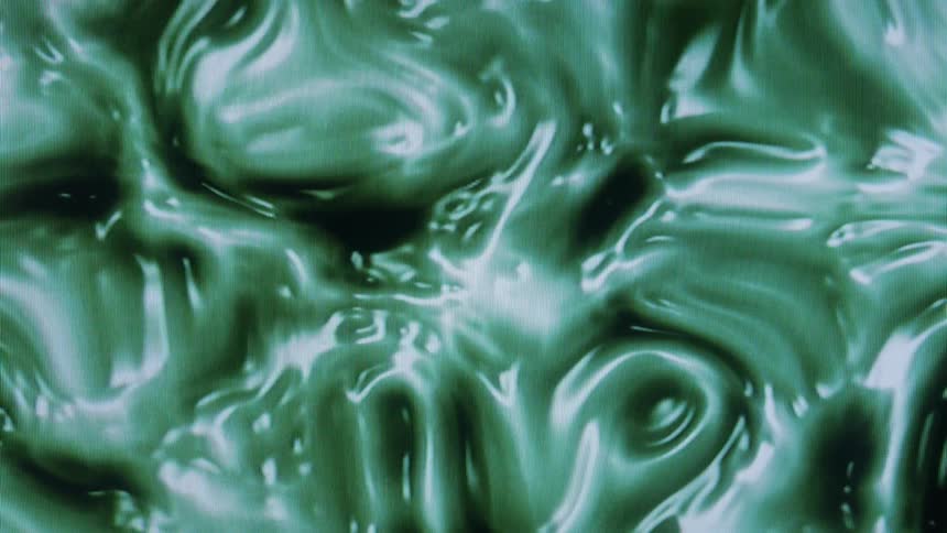 Close up abstract of thick green liquid swirling around