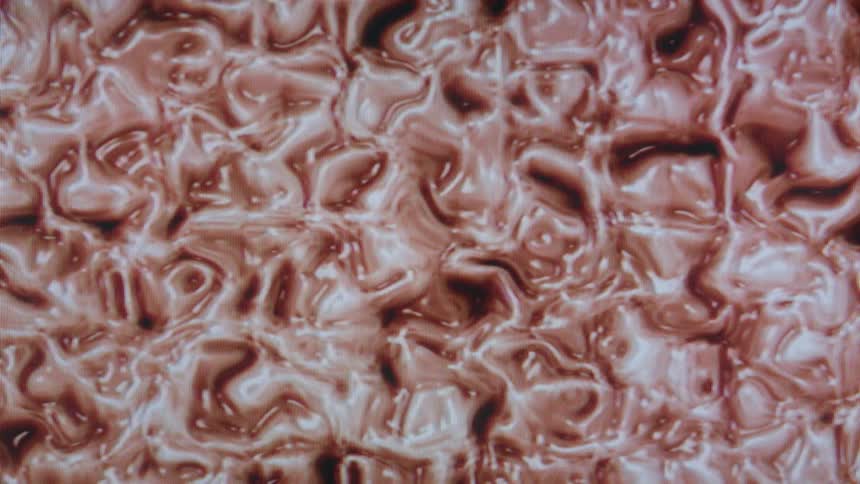 Swirling patterns of red and white paint create an abstract marbled design