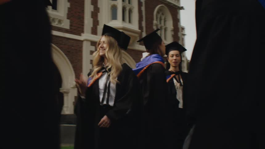 Graduates talk in a group together outside