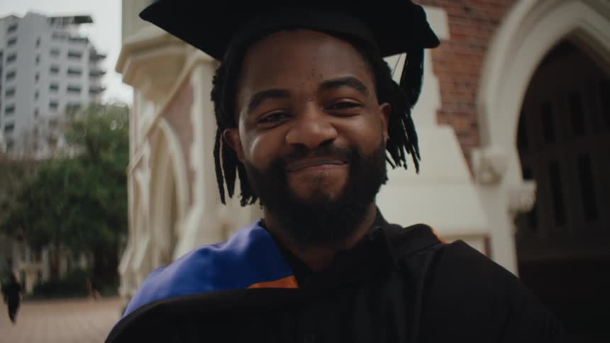 Portrait of a happy man with graduation gown