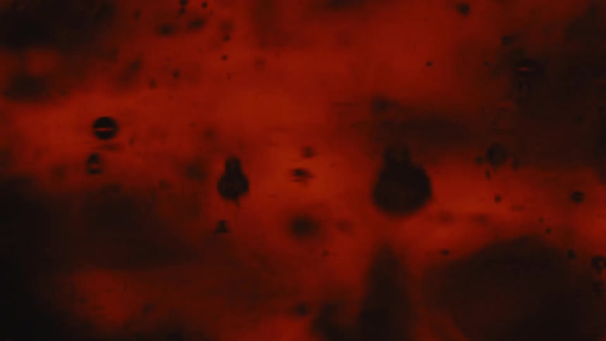 Red liquid with bubbles of different sizes