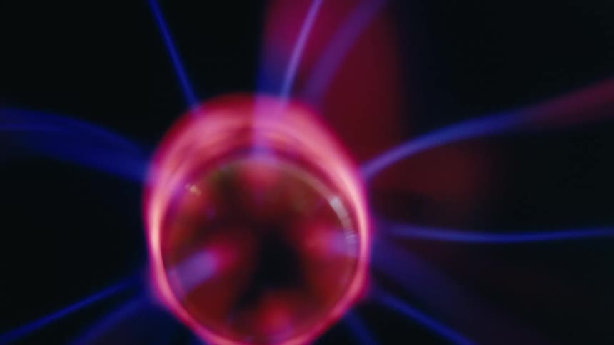 A close up of bright electric discharges inside a plasma ball