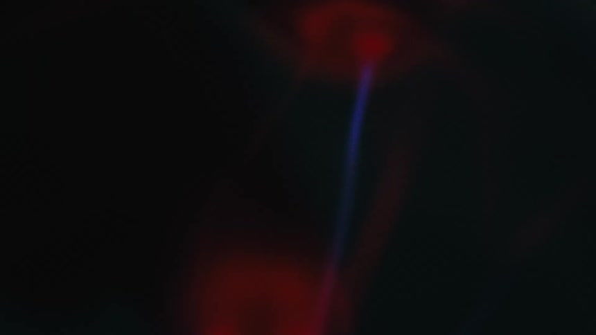 A dark background with streaks of red and blue light