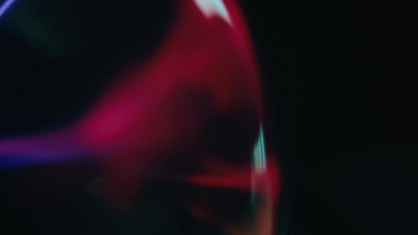 Close up of a sphere emitting abstract neon lights