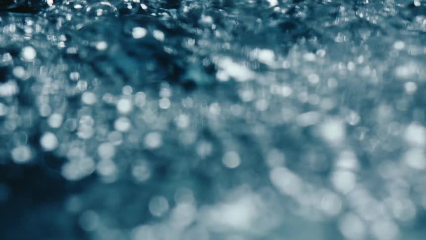 Extreme close up of water with moving bubbles