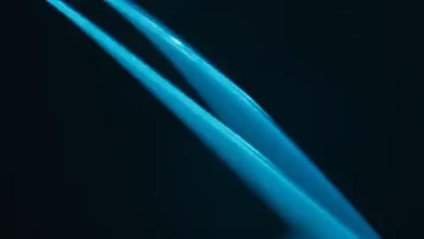 Neon light with reflections against a black background