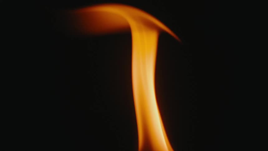 A dancing flame flickers against a dark background