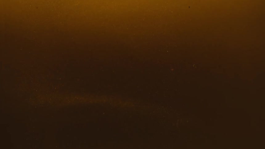 Extreme close up on an abstract golden liquid
