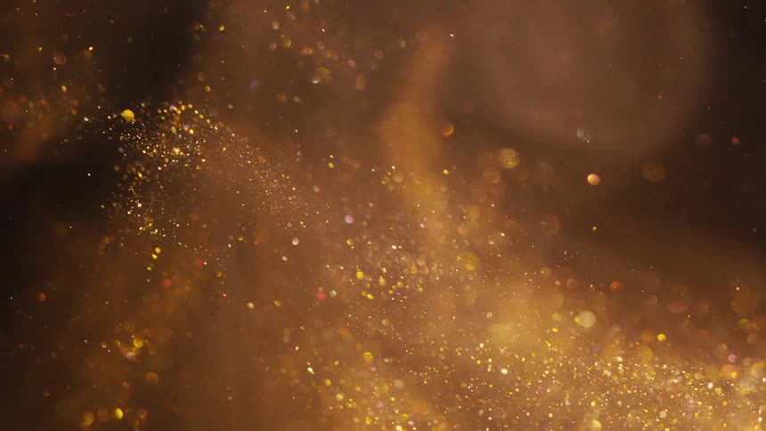 Dense liquid with golden glitter in abstract motion