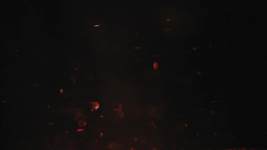 Dark blue liquid is sprinkled with small red sparkly dots