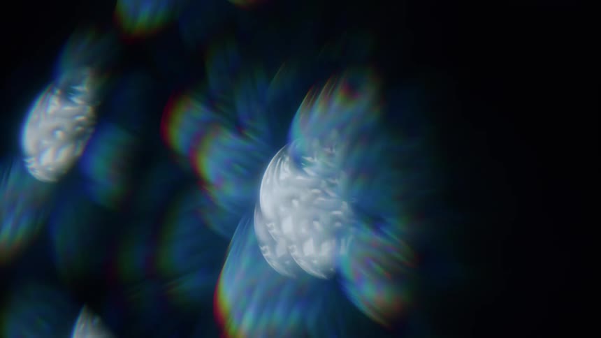 Light displaying a prism effect contrasts with the darkness
