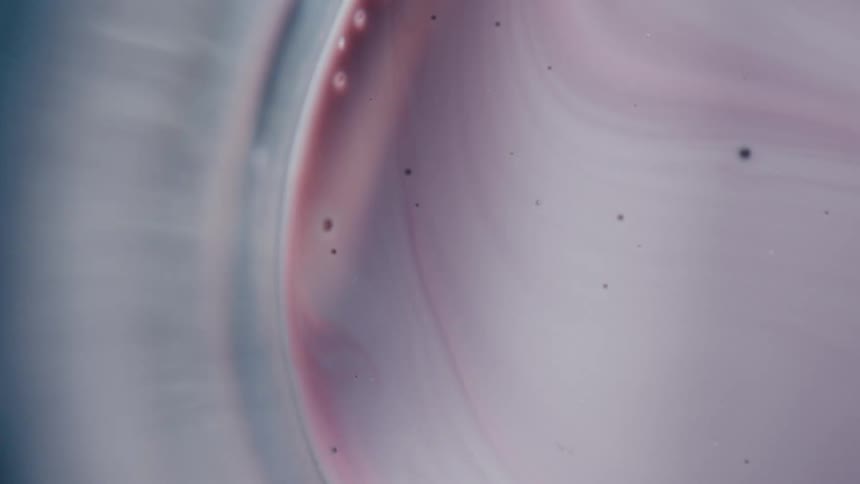 A swirling vortex of pale pink and blue hues creates a mesmerizing otherworldly pattern