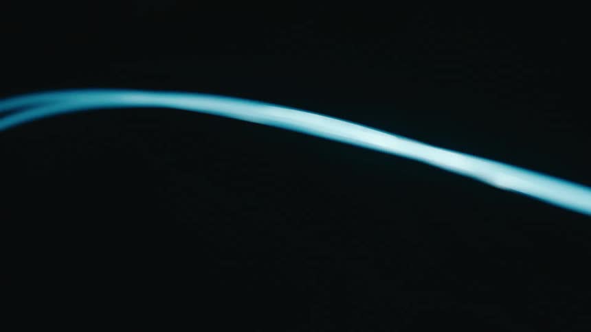 Neon blue light beam against a dark background