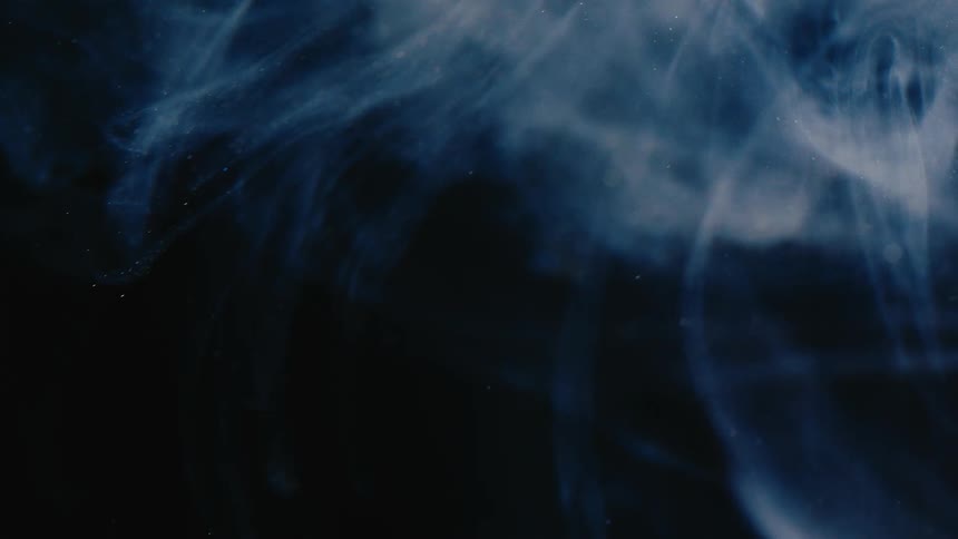 Dense shiny whitish liquid on a black background
