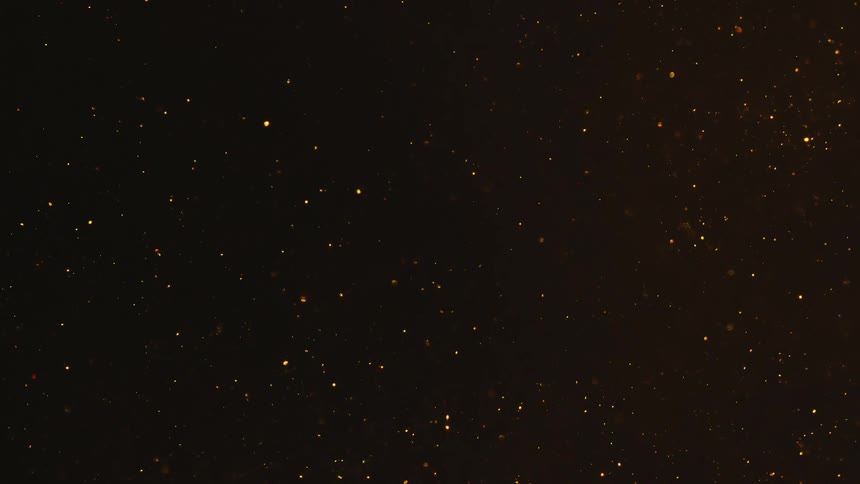 Tiny glowing particles float in a dark expanse