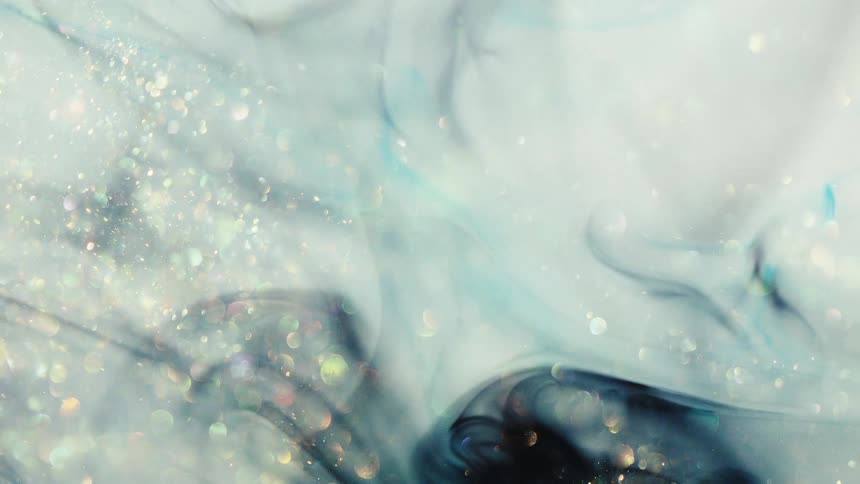 Swirling patterns of blue and white paint with scattered glitter create an abstract marbled design
