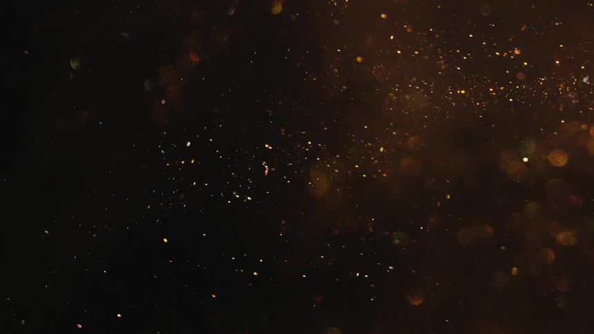 Swirling patterns of floating gold paint with scattered glitter create an abstract design
