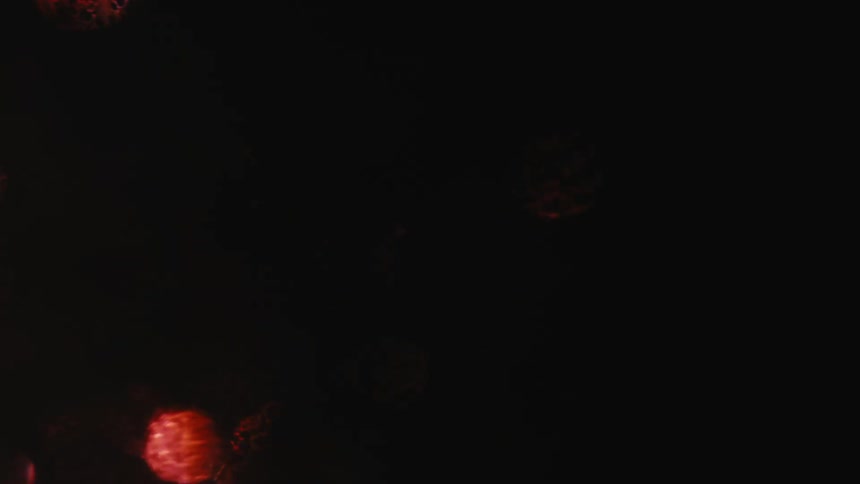 Red outoffocus orbs float in a dark space