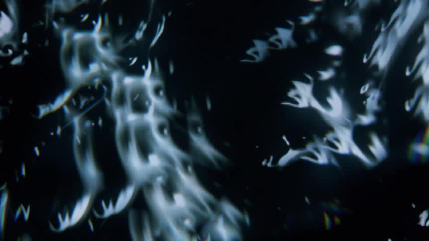 A dark background with abstract swirling patterns of light and dark