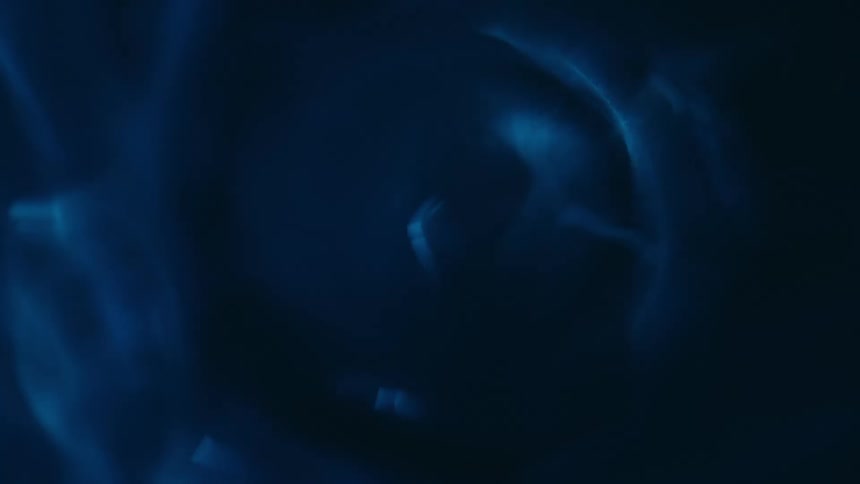 Reflections of light ripple over a blue surface