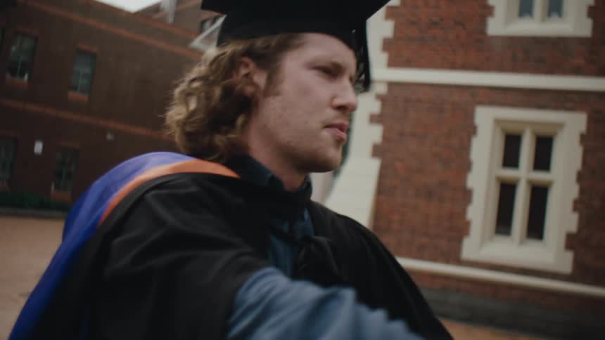 A clip of graduate students embracing each other
