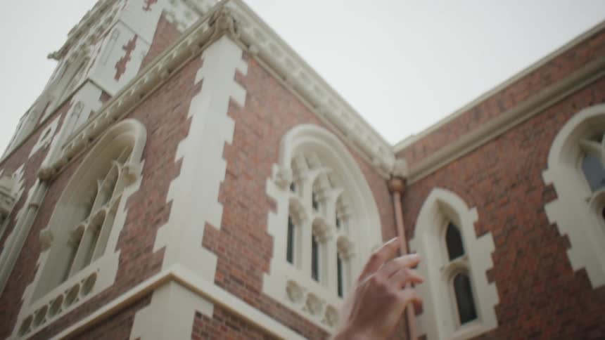 Male student throwing his graduation cap into the air