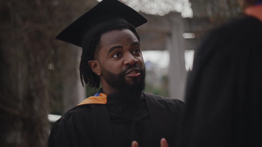 Graduates having a conversation in their academic clothing