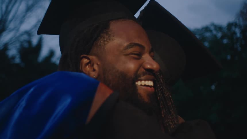 A clip of graduate sharing a hug