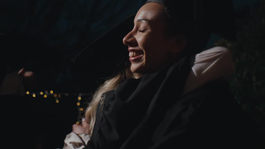 College graduates hugging each other in accomplishment