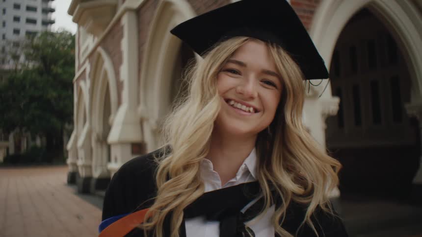 Portrait of a smiling woman in graduation gown