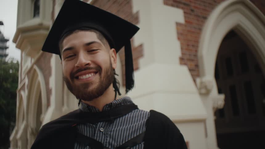 Portrait of a happy man with graduation gown