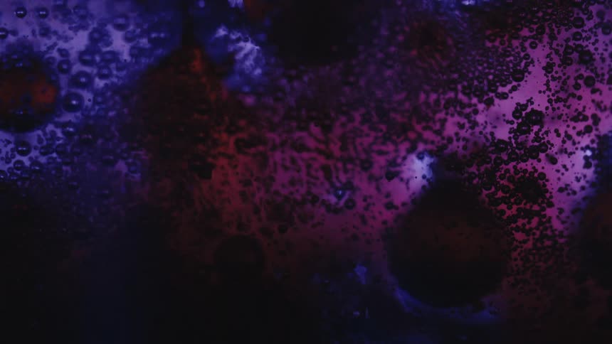 Dense coagulated liquid with bubbles in pink and purple coloration