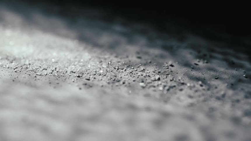 Dust shakes on a gray colored textured surface
