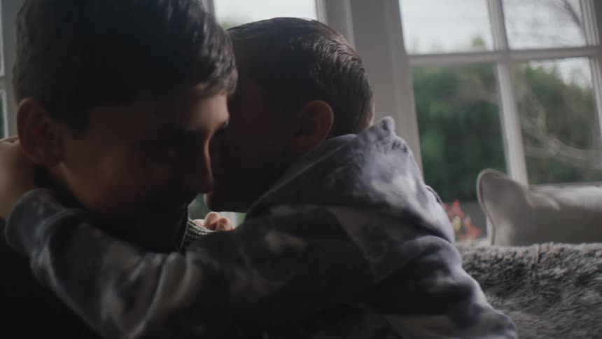 Two little boys whispering and laughing