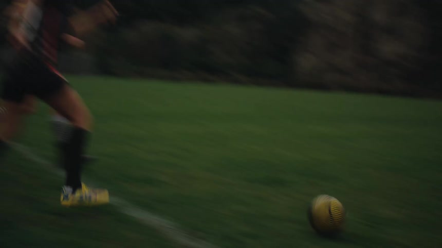 Boys and girls playing soccer on a grass field
