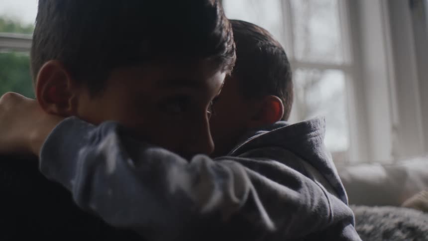 Two boys laughing and whispering