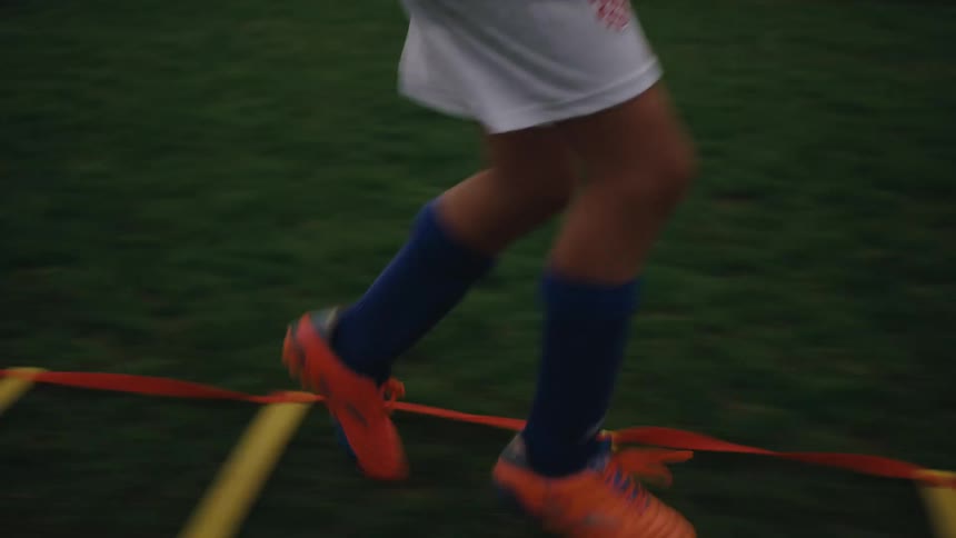 A boy running on a soccer field training track