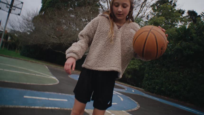 Girl playing basketball on a court