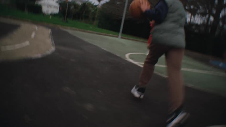 Children playing basketball on a basketball court