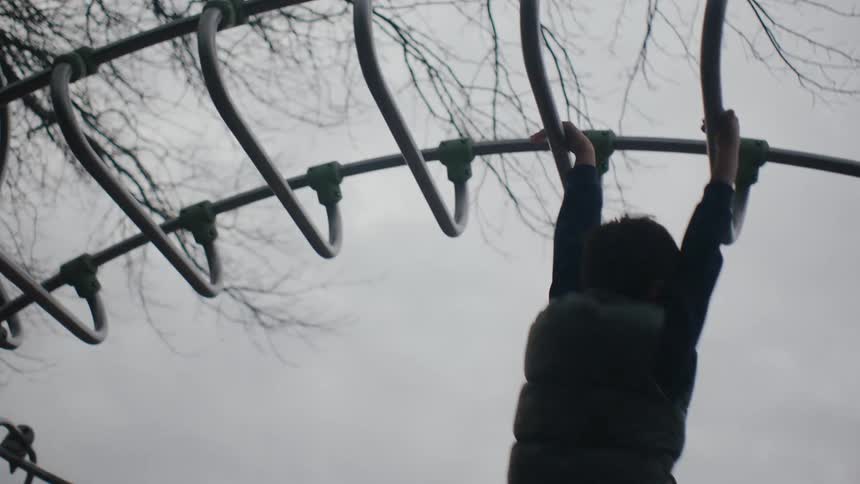 Little boy in a playground playing on a toy