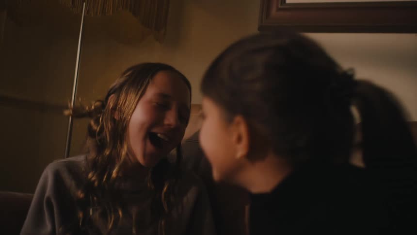 Two girls having fun in the couch at home