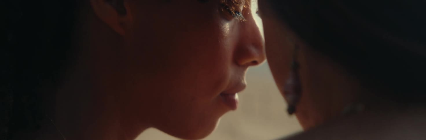 Two women with faces close to each other