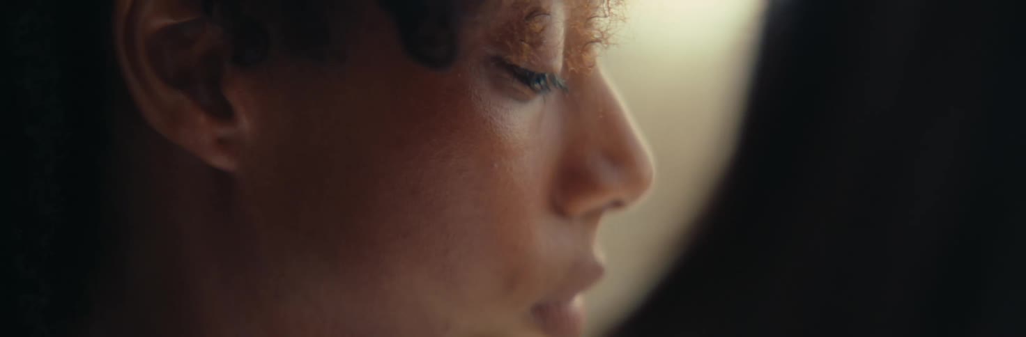 A woman slowly looks to her side
