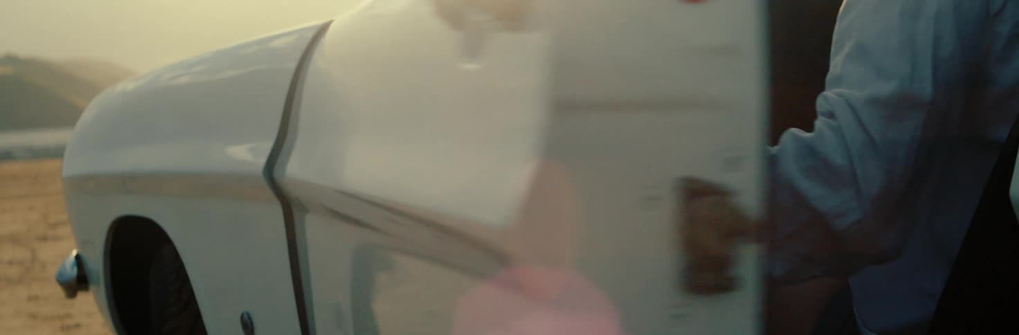 A woman is sitting in her car and closes the door
