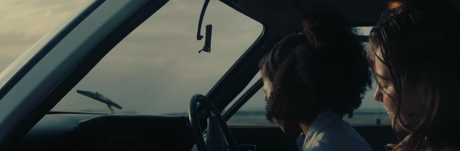 Woman getting in and sitting inside the car