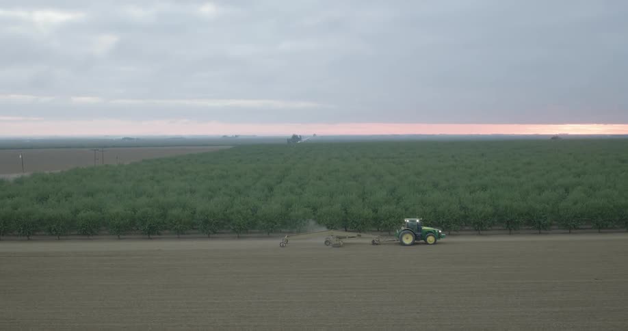Aerial view of a machine harvesting an agricultural field