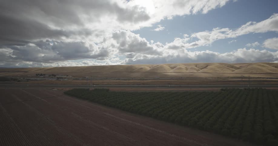 Panorama of an agricultural field with mountains in the background