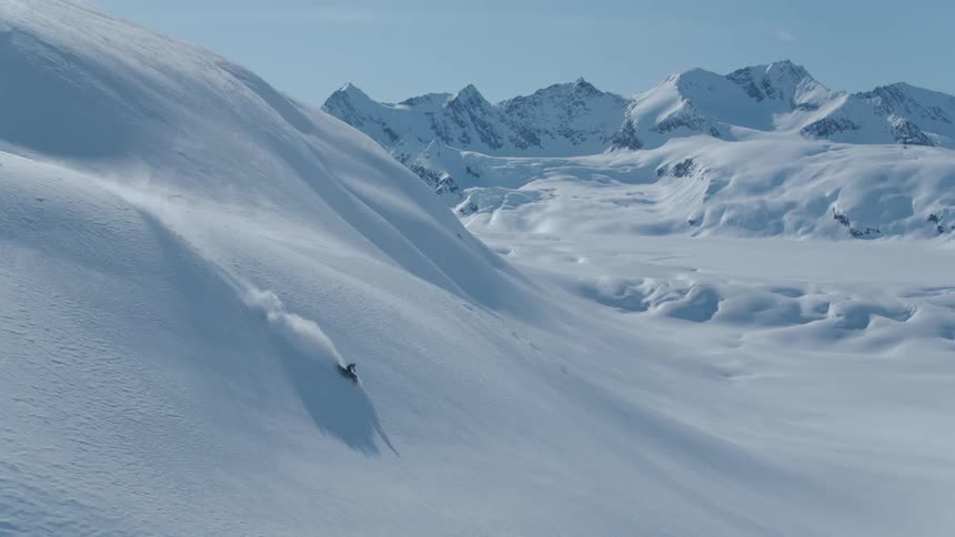 Aerial view of a snowmobile person jumping