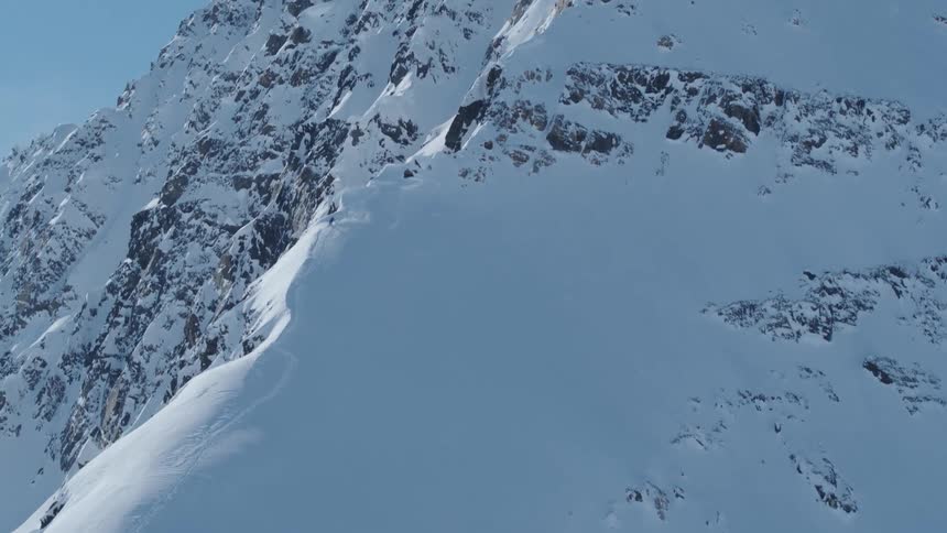 Aerial view of a person skiing down a snowy mountain