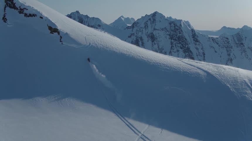Person on a snowmobile climbing a mountain
